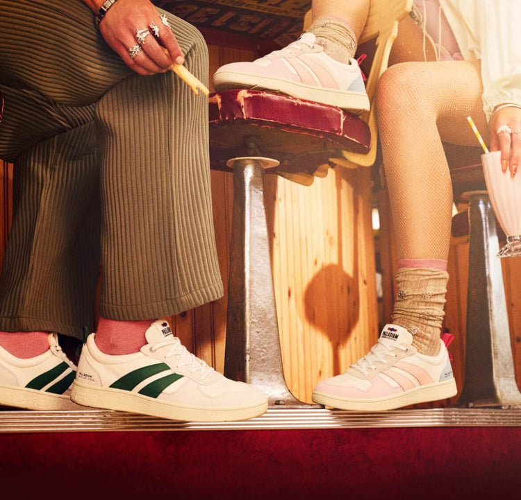 Man and woman sitting in a diner wearing Pallacup Flame LTH shoes