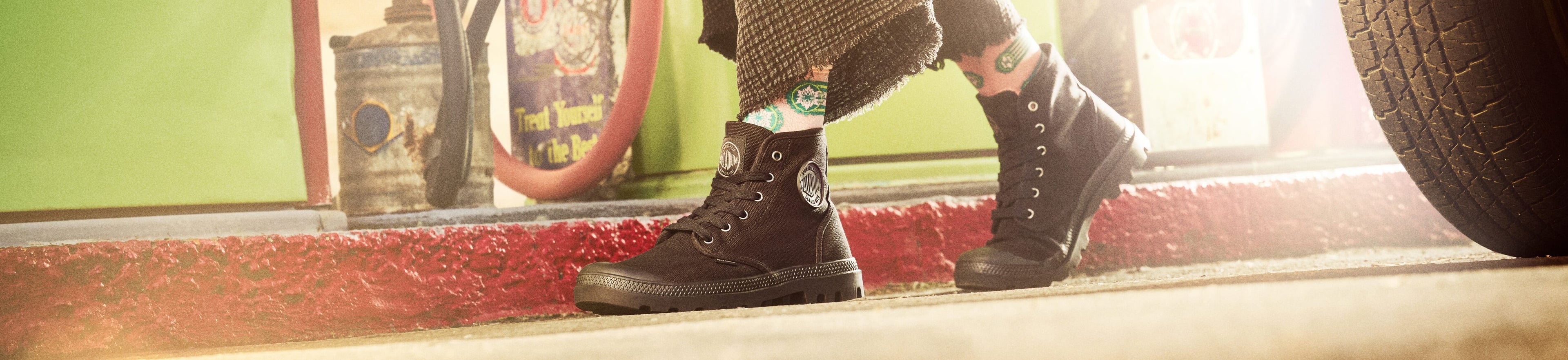 Image of someone wearing the Palladium Pampa Hi in black while at a gas station