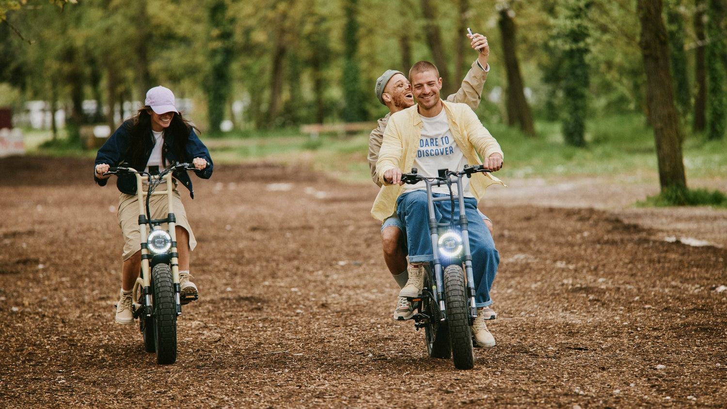Group of friends riding motorbikes on a dirt path wearing Palladium shoes. 