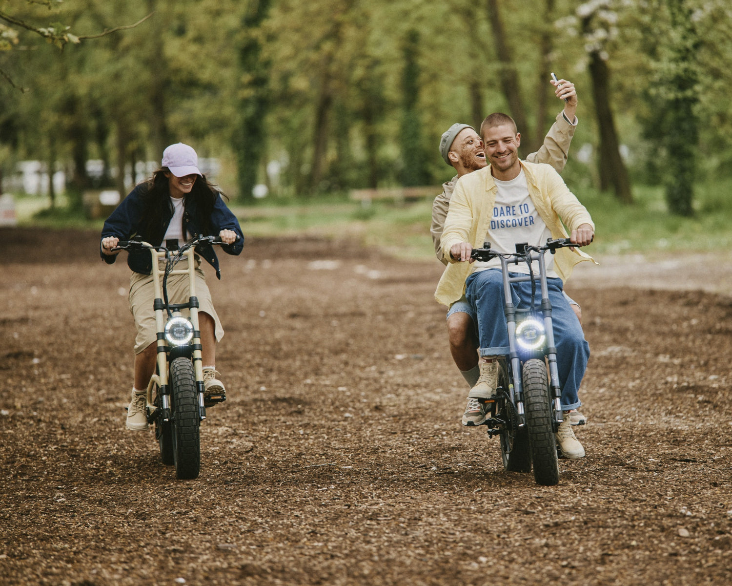 Group of friends riding motorbikes on a dirt path wearing Palladium shoes. 