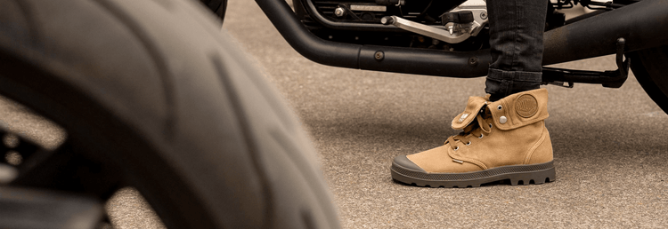 Image of the Baggy shoe next to a motorcycle and tire